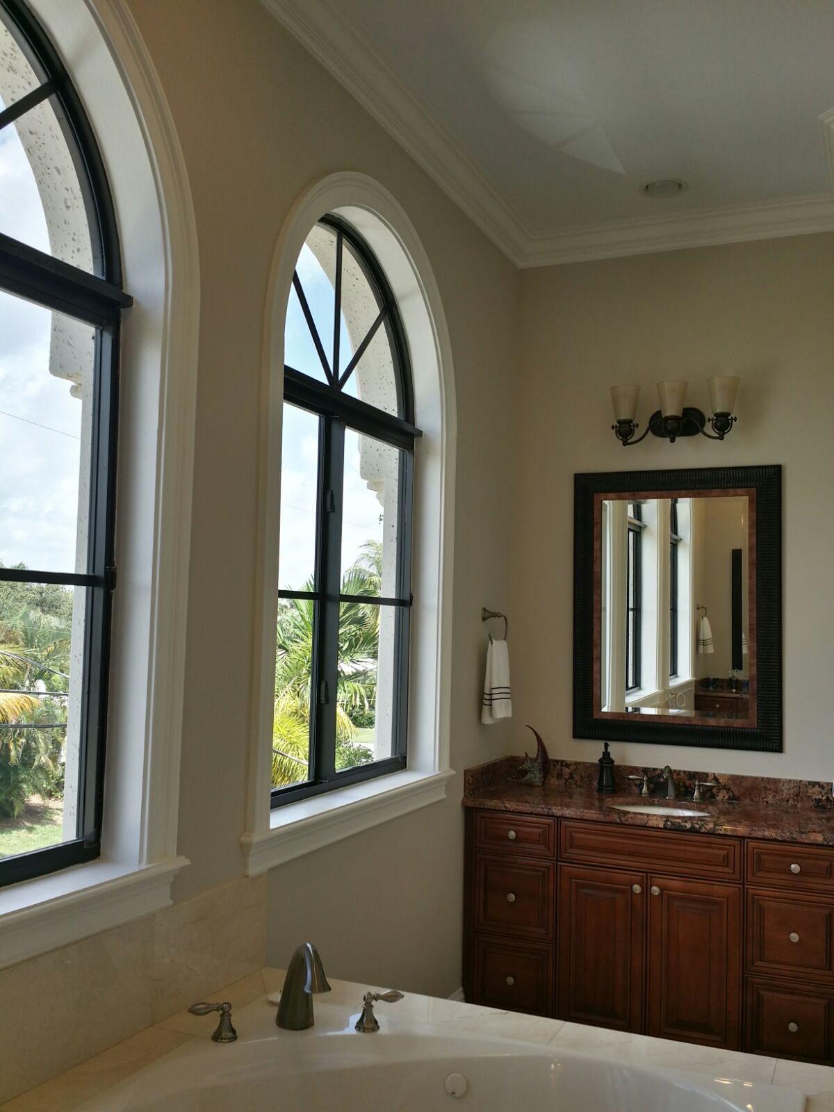 Side view of uncovered arched bathroom windows