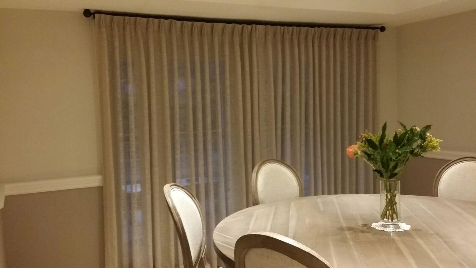 Sheer curtains on a decorative rod in a dining room